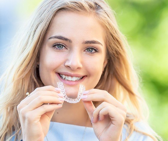 Woman placing Nu Smile Aligner tray