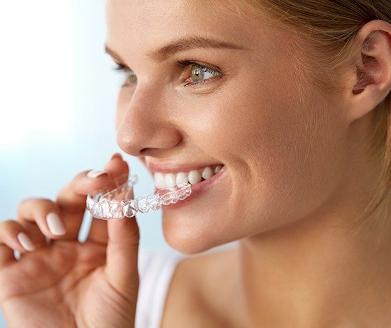 Woman placing a Nu Smile Aligner tray