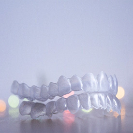Closeup of Invisalign aligners in Barnegat on colorful background