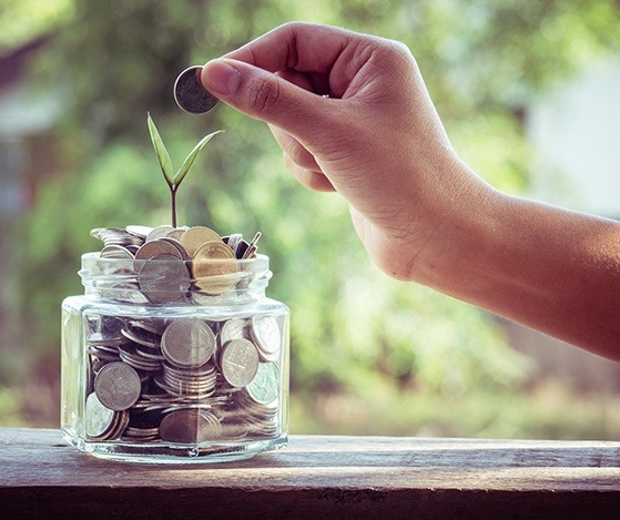 Person placing coins in a jar