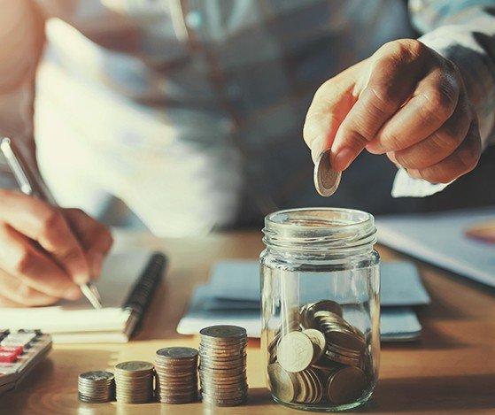 Person placing coins in a jar