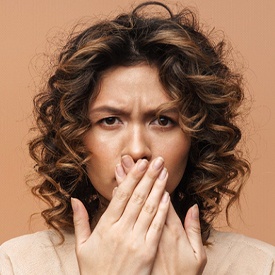 Woman bothered by problems caused by crooked teeth