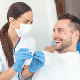 Patient and dentist discussing the cost of Invisalign in Eatontown