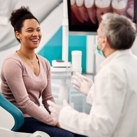 Dentist and patient discussing alternative to Invisalign treatment in Brick  