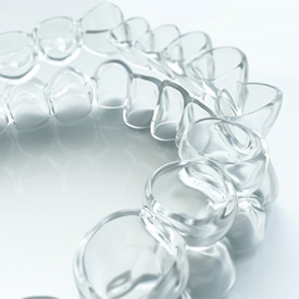 Closeup of clear aligners in brick on white background 