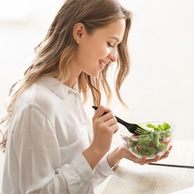 woman eating salad with fork