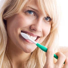 closeup of woman brushing teeth