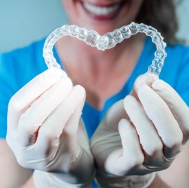 dentist making hearts with clear aligners