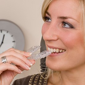 Woman with Invisalign in Brick with a clock in the background