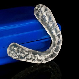 Invisalign retainer with its blue storage case