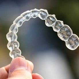 Closeup of Invisalign in Barnegat on colorful background 
