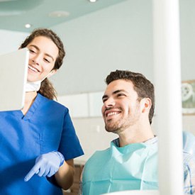 Patient and dentist discussing how Invisalign works in Staten Island 