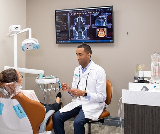 Invisalign alternative dentist in Brick speaking with patient 