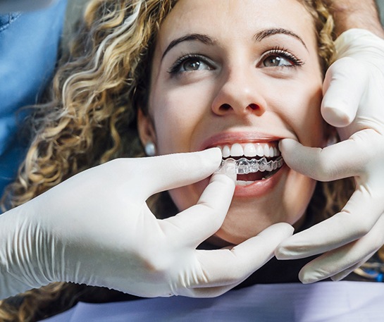 Woman smiling after learning the cost of Invisalign in Eatontown